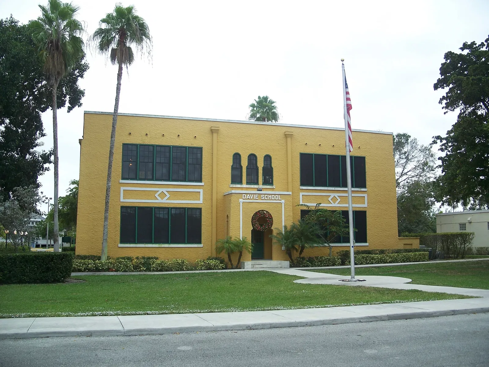 Historic Old Davie School building beneath palms in Davie, Florida